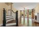 Sun-filled living room adjacent to staircase featuring a fireplace and large arched windows at 550 Vinings Springs Se Dr, Mableton, GA 30126