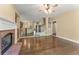 Open-concept living room with fireplace, wood floors and views to kitchen and stairway at 550 Vinings Springs Se Dr, Mableton, GA 30126