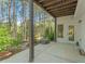 Covered outdoor patio with wooded views, perfect for relaxing and entertaining at 550 Vinings Springs Se Dr, Mableton, GA 30126