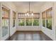 Charming sunroom with natural light, hardwood floors and multiple windows with wooded views at 550 Vinings Springs Se Dr, Mableton, GA 30126