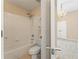 Well-lit bathroom featuring white tiling and tub-shower combo at 550 Vinings Springs Se Dr, Smyrna, GA 30126