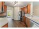 Well-lit kitchen with stainless steel appliances, wooden cabinets, and hardwood floors at 550 Vinings Springs Se Dr, Smyrna, GA 30126