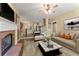 Inviting living room with a fireplace, open floor plan, and a staircase to the upper level at 550 Vinings Springs Se Dr, Smyrna, GA 30126