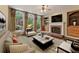 Comfortable living room with stylish seating, fireplace, built-in shelves and large windows at 550 Vinings Springs Se Dr, Smyrna, GA 30126