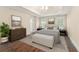 Bedroom featuring a tray ceiling, wood floors, and a neutral color scheme with a luxurious feel at 550 Vinings Springs Se Dr, Smyrna, GA 30126