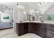 Primary bathroom with dark wood cabinets, double sinks, and a walk-in shower, offering a luxurious feel at 6062 Fielder Way, Douglasville, GA 30135