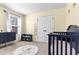 This Bedroom has a cute rug and crib, creating a sweet space at 6062 Fielder Way, Douglasville, GA 30135