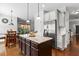 Modern kitchen featuring a center island, stainless steel appliances, and an open layout to the dining area at 6062 Fielder Way, Douglasville, GA 30135