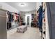 Spacious walk-in closet with ample storage, featuring shelving, hanging rods, and an ottoman at 6062 Fielder Way, Douglasville, GA 30135