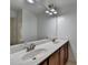 Bathroom featuring double sink vanity with dark wood cabinets and chrome fixtures at 2272 Misty Brook Ct, Buford, GA 30519