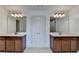 Primary bathroom featuring double vanities and mirrors with white trim and a tiled shower at 2272 Misty Brook Ct, Buford, GA 30519