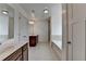 This bathroom features dual sinks, a separate tub and shower, and neutral tile flooring at 2272 Misty Brook Ct, Buford, GA 30519