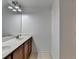 Bathroom featuring double sink vanity with dark wood cabinets and chrome fixtures at 2272 Misty Brook Ct, Buford, GA 30519