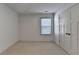 Simple bedroom features neutral carpet, a double door closet, and a window at 2272 Misty Brook Ct, Buford, GA 30519