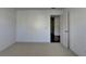 Bedroom featuring neutral carpet and a view into an adjacent room at 2272 Misty Brook Ct, Buford, GA 30519