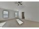 This bedroom features neutral carpeting, two windows providing natural light, and a modern ceiling fan at 2272 Misty Brook Ct, Buford, GA 30519