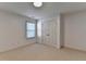 Simple bedroom features neutral carpet, a double door closet, and a window at 2272 Misty Brook Ct, Buford, GA 30519