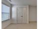 Bright bedroom featuring a window with blinds and a spacious closet with white doors at 2272 Misty Brook Ct, Buford, GA 30519