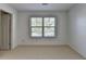 Bedroom featuring a large window and neutral carpet at 2272 Misty Brook Ct, Buford, GA 30519