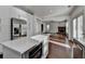 Bright kitchen flows into the living room with stainless steel appliances and white cabinets at 2272 Misty Brook Ct, Buford, GA 30519
