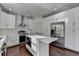 Bright kitchen features stainless steel appliances, white cabinets, and hardwood floors at 2272 Misty Brook Ct, Buford, GA 30519