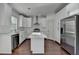 Well-lit kitchen featuring white cabinets, an island, and stainless steel appliances at 2272 Misty Brook Ct, Buford, GA 30519