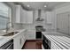 Bright kitchen features a stainless steel range hood, and white subway tile backsplash at 2272 Misty Brook Ct, Buford, GA 30519