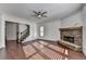 Spacious living room showcasing hardwood floors, a fireplace, and a staircase at 2272 Misty Brook Ct, Buford, GA 30519