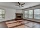 Bright living room featuring a stone fireplace, hardwood floors, and lots of natural light at 2272 Misty Brook Ct, Buford, GA 30519