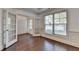 Office featuring glass panel doors, hardwood floors, and natural lighting at 2272 Misty Brook Ct, Buford, GA 30519