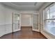 Office featuring glass panel doors, hardwood floors, and natural lighting at 2272 Misty Brook Ct, Buford, GA 30519