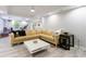 Comfortable basement with a light tan sectional, a white table and nice lighting at 415 Oak Laurel Ct, Johns Creek, GA 30022