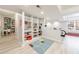 Spacious finished basement featuring built-in shelving, rec area, and stylish flooring at 415 Oak Laurel Ct, Johns Creek, GA 30022