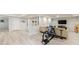 Spacious basement featuring laminate flooring, a television, sectional sofa, and exercise equipment at 415 Oak Laurel Ct, Johns Creek, GA 30022