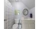 Bright bathroom with a toilet, vanity, and a shower with a charming patterned shower curtain at 415 Oak Laurel Ct, Johns Creek, GA 30022