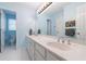 Light blue bathroom features dual sinks, lots of storage and a tiled floor at 415 Oak Laurel Ct, Johns Creek, GA 30022