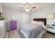 Well lit bedroom with a bed, a dresser, a lamp, and laminate wood flooring at 415 Oak Laurel Ct, Johns Creek, GA 30022