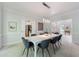 Bright dining room features modern lighting, white walls, and access to kitchen at 415 Oak Laurel Ct, Johns Creek, GA 30022