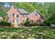 Beautiful two-story brick home with a manicured lawn and mature landscaping at 415 Oak Laurel Ct, Johns Creek, GA 30022