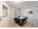 Finished basement featuring a pool table, door to the backyard, and ample lighting at 415 Oak Laurel Ct, Johns Creek, GA 30022