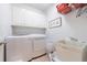 Convenient laundry room with white cabinets, sink, and modern washer and dryer at 415 Oak Laurel Ct, Johns Creek, GA 30022