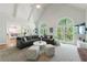 Open floor plan features vaulted ceilings, a brick fireplace, and large windows at 415 Oak Laurel Ct, Johns Creek, GA 30022