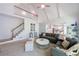 Bright living room with high ceilings, staircase, and open floor plan to kitchen at 415 Oak Laurel Ct, Johns Creek, GA 30022