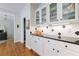 Pantry features granite countertops, glass front cabinets, and ample storage space at 415 Oak Laurel Ct, Johns Creek, GA 30022