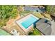 Aerial view of a community pool, parking lot, and playground in a wooded setting at 415 Oak Laurel Ct, Johns Creek, GA 30022