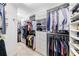 Large walk-in closet featuring built in shelves and hanging racks at 415 Oak Laurel Ct, Johns Creek, GA 30022