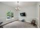 Cozy bedroom with natural light, modern light fixture, and a neutral color scheme at 5640 Rolling Oaks Dr, Cumming, GA 30040