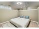 Basement bedroom with neutral walls, carpeted floor, bed, and small window at 5640 Rolling Oaks Dr, Cumming, GA 30040