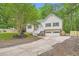 Exterior of a two-story home with a well-manicured lawn, driveway, and attached garage at 5640 Rolling Oaks Dr, Cumming, GA 30040