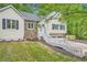 Well-maintained two-story home exterior featuring stone accents and a landscaped yard at 5640 Rolling Oaks Dr, Cumming, GA 30040